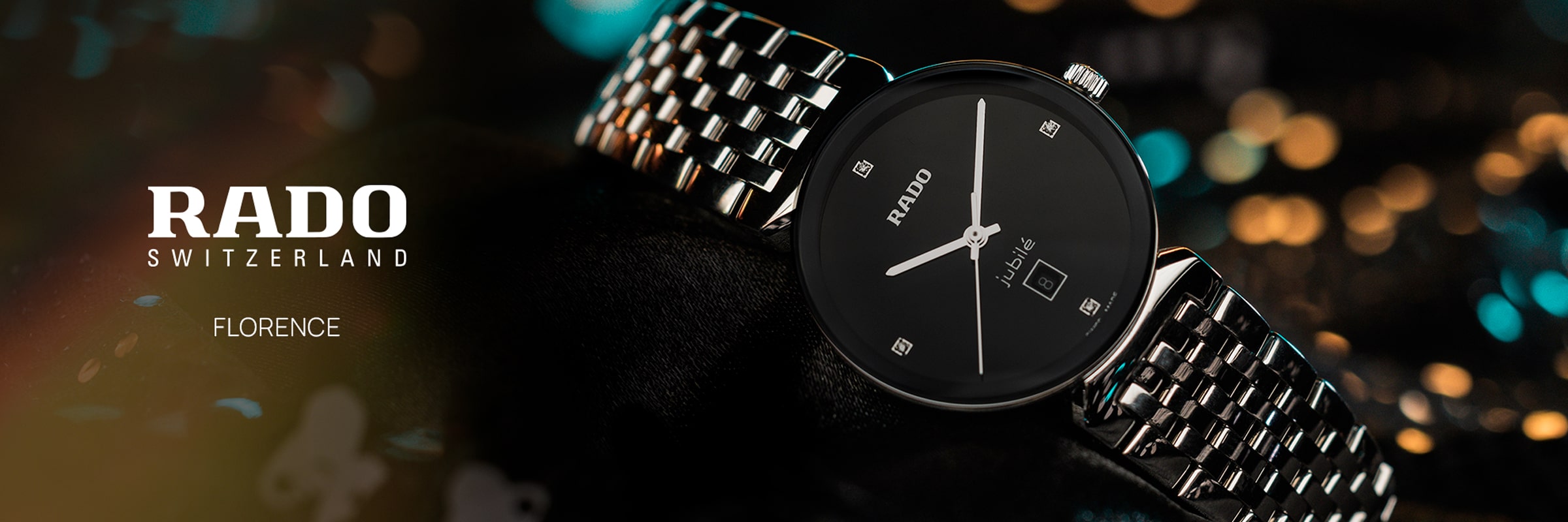 2025 © RADO Eine Nahaufnahme einer eleganten Rado Florence Armbanduhr mit schwarzem Zifferblatt, silbernen Markierungen und einem silbernen Metallarmband vor einem verschwommenen, bunten Hintergrund mit dem Text "Rado Switzerland Florence".