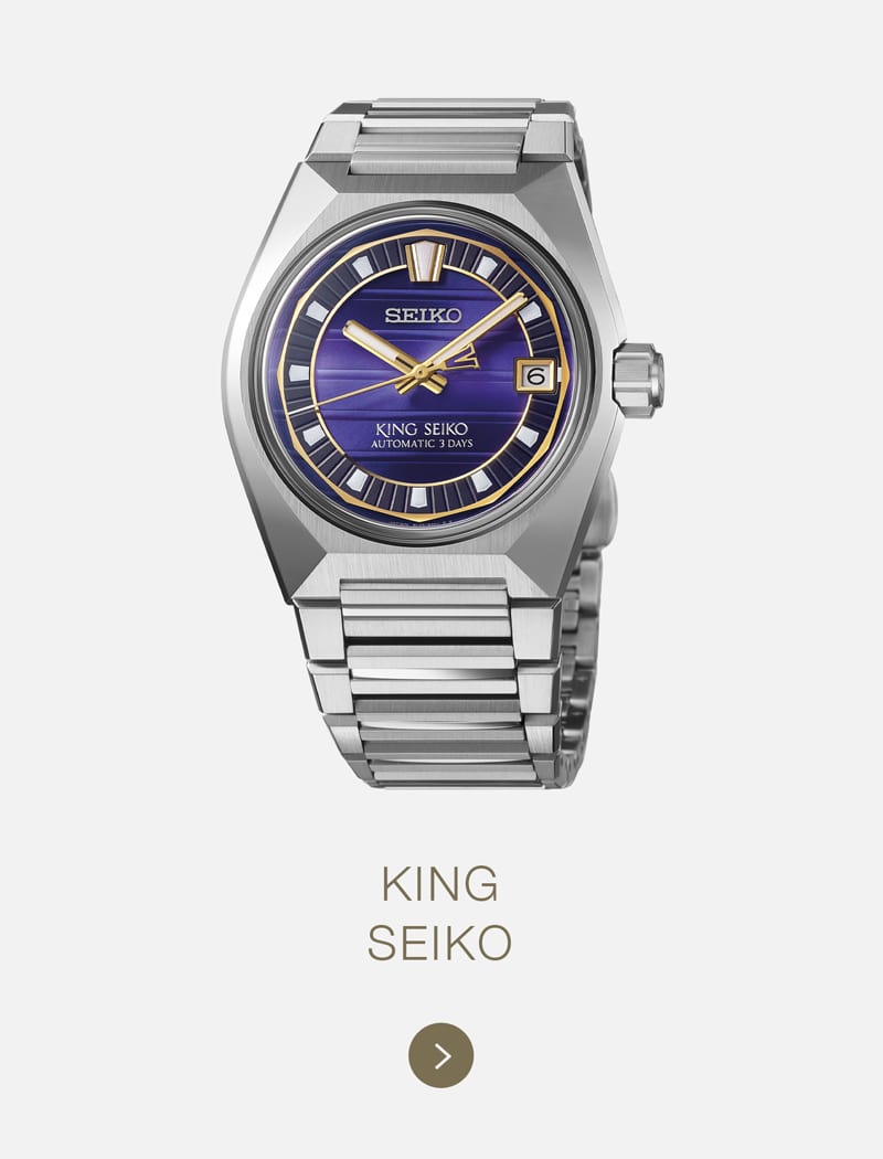 Eine silberne Seiko-Armbanduhr mit Metallband, blauem und goldfarbenem Zifferblatt, Datumsanzeige und dem Text "KING SEIKO AUTOMATIC 3 DAYS" auf weißem Hintergrund, darunter die Aufschrift "KING SEIKO".